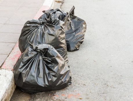 Commercial waste vehicles lined up outside a Hanwell shopfront