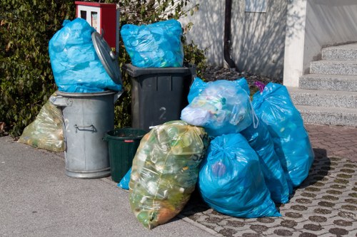 Crew loading commercial waste into a collection vehicle